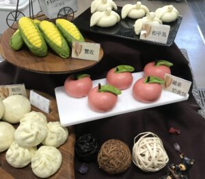 Dispaly of bread rolls shaped to resemble a variety of fruits and animals.