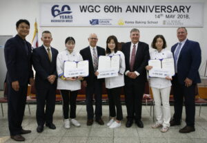 People pose in a line during an award presentation. 