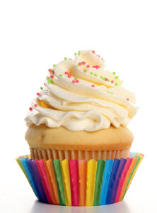 vanilla cupcake in a rainbow paper wrapper