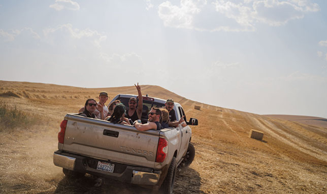 Traveling the dirt roads and through the fields, the brewers are able to see barley being harvested.