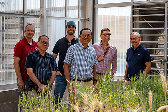 Arron Carter in greenhouse with trade team