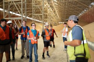 Josh Hernadez (right) of CHS SunBasin Growers answers questions from high school students about working in a grain elevator.