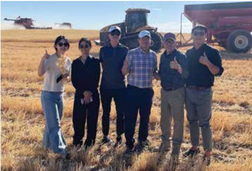 After meeting Washington Grain Commission Chairman Kevin Klein in a club wheat field, members of the Korean Crop Survey Trade Team enjoyed a first-hand harvest tour, complete with combine rides with the farmers who produce the wheat that becomes their flour and foods.